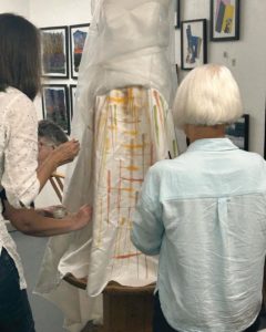 Two ladies adjusting a dress during Tanys Transformations