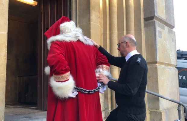 An officer taking Santa to Shepton Mallet Prison