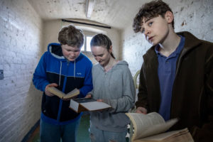 A group of friends trying to work out a clue during The Cell escape room